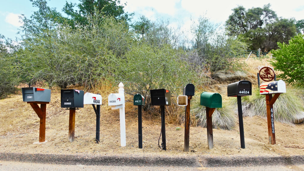 10 mailboxes lined up on a street